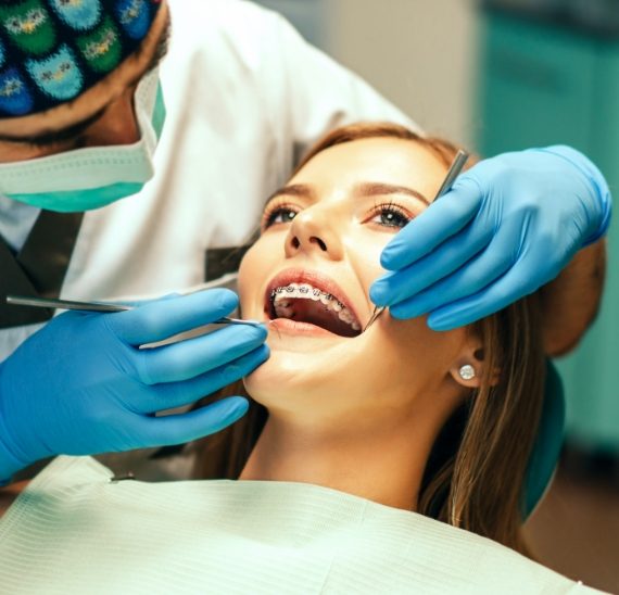 dentist-examine-female-patient-with-braces-denal-office